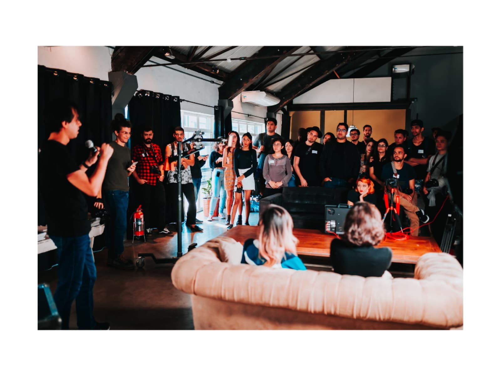 A speaker addresses an engaged audience at an evening gathering.