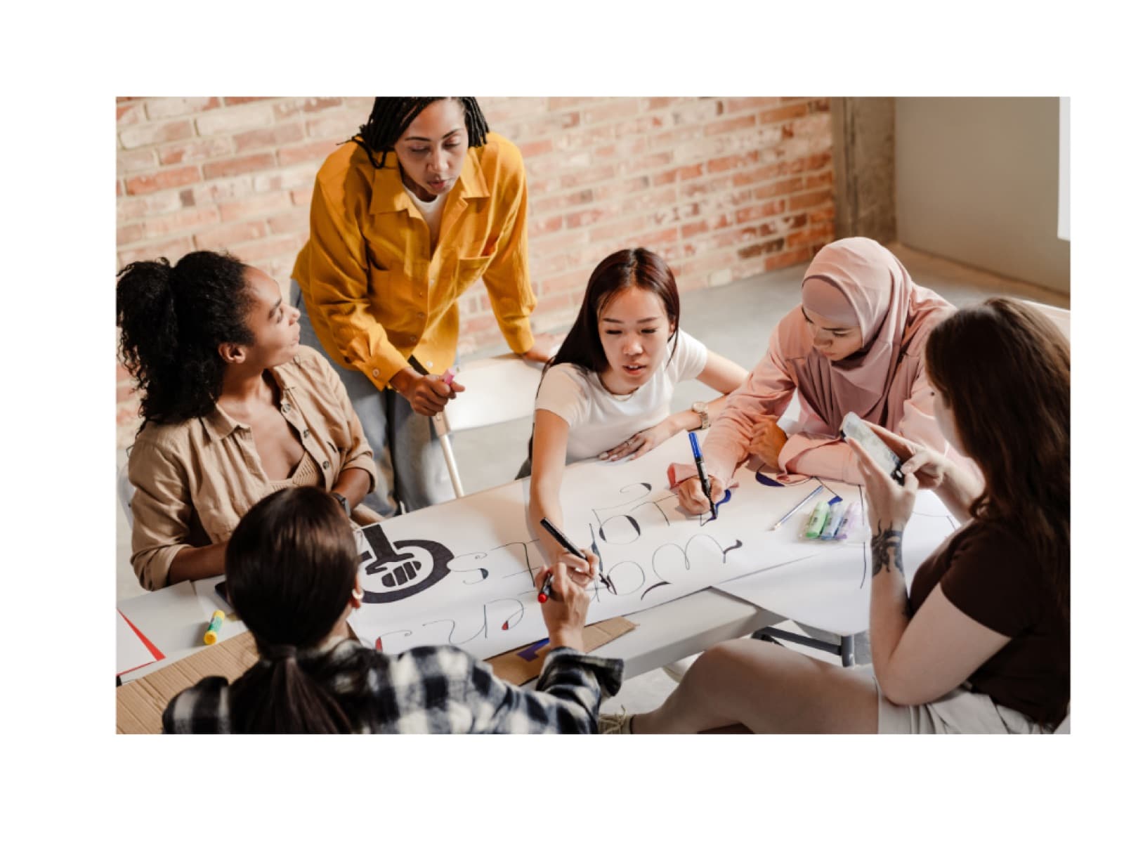 Community leaders map out a plan together around a table.
